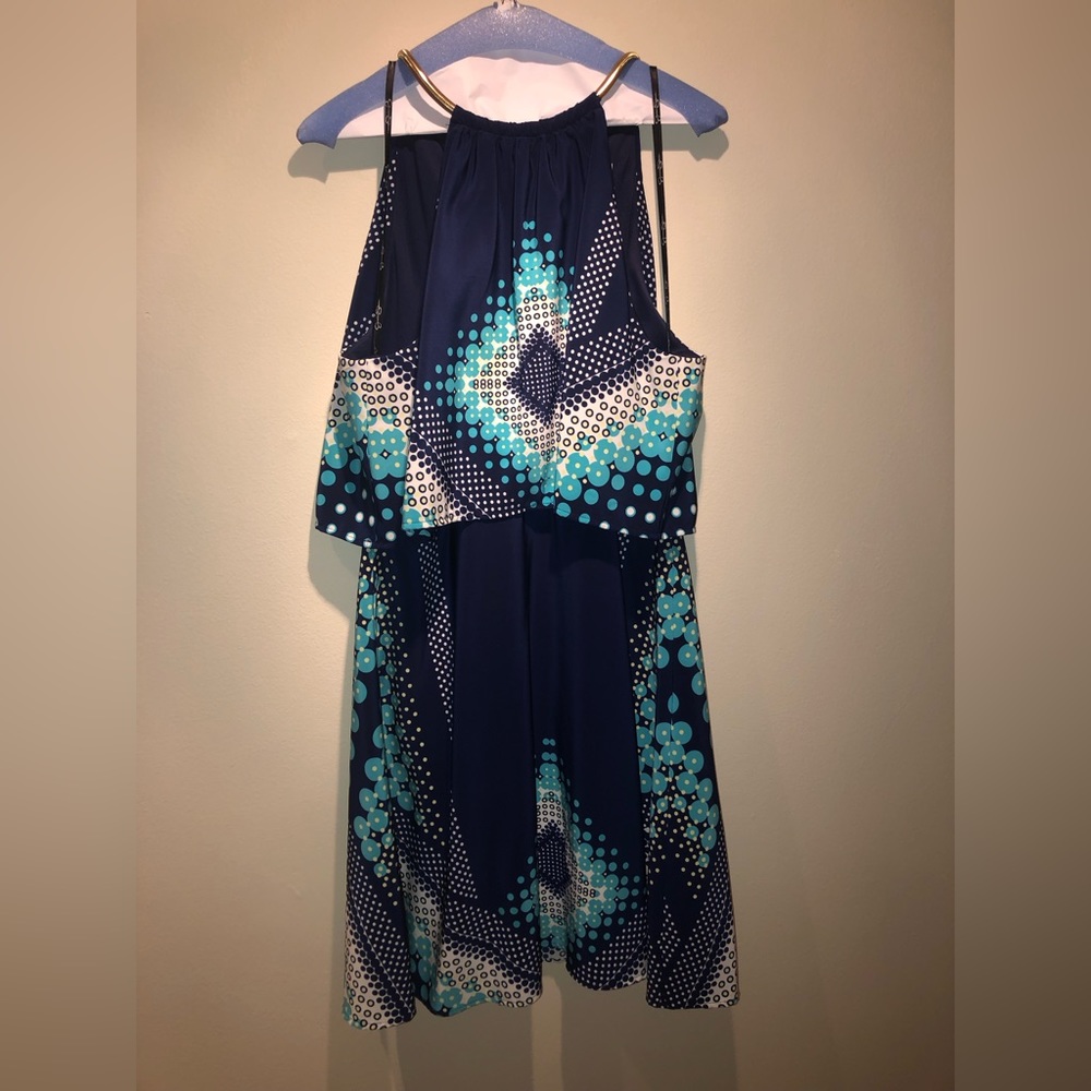 Fit and flair halter dress, metal neckline, flutter top.